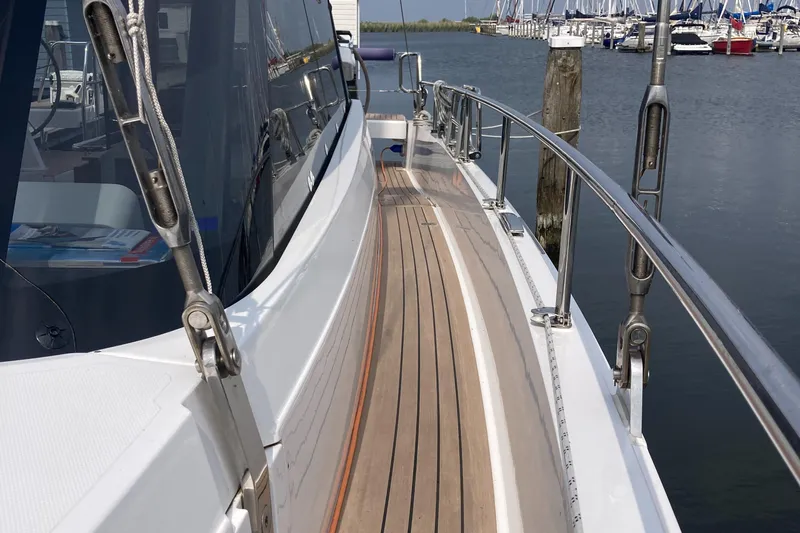  Yacht Photos Pics 2022 Moody Decksaloon 41 yacht with sleek wooden deck and stainless steel railings.