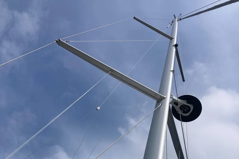  Yacht Photos Pics Mast of 2022 Moody Decksaloon 41 sailboat against a cloudy sky.