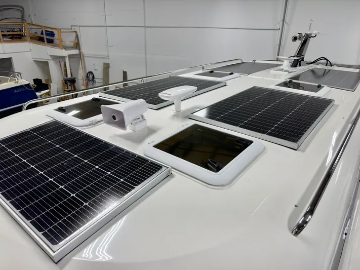  Yacht Photos Pics Rooftop solar panels on 2026 Aspen C108 boat in a workshop setting.