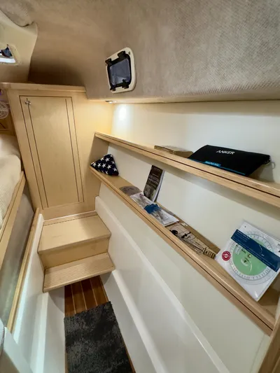  Yacht Photos Pics Cozy interior of 2026 Aspen C108 boat with wooden shelves and compact design.
