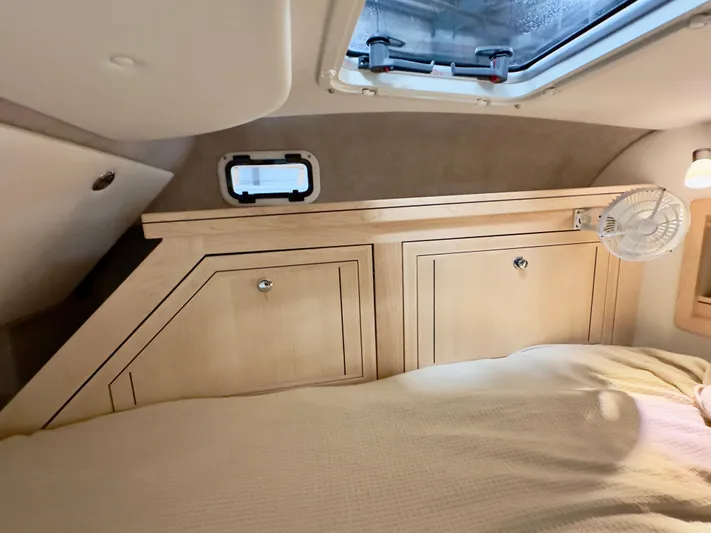  Yacht Photos Pics Cozy interior of 2026 Aspen C108 with wooden cabinets and a small window.