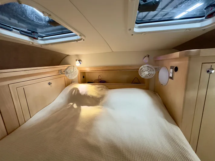  Yacht Photos Pics Cozy cabin interior of 2026 Aspen C108 with skylights and wooden cabinetry.