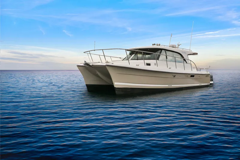  Yacht Photos Pics 2026 Aspen C108 catamaran on calm ocean under clear blue sky.