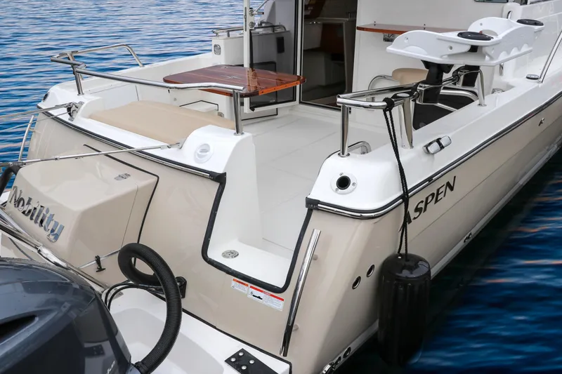  Yacht Photos Pics Aspen C108 2026 boat with spacious deck and seating on calm water.