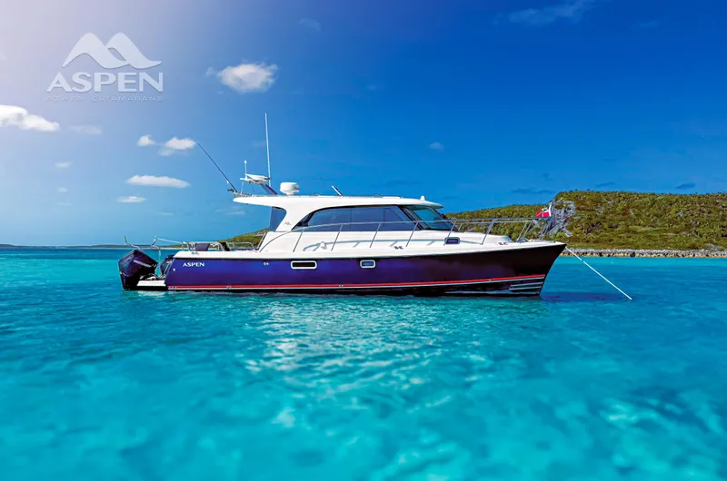  Yacht Photos Pics 2026 Aspen C108 boat anchored in clear blue water under a sunny sky.