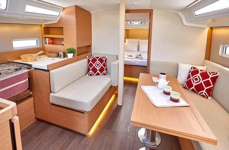  Yacht Photos Pics 2026 Jeanneau Sun Odyssey 410 interior with modern design, cozy seating, and elegant dining area.
