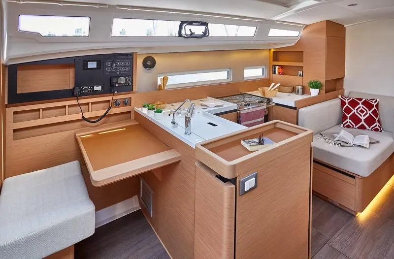  Yacht Photos Pics Modern interior of 2026 Jeanneau Sun Odyssey 410 yacht with sleek kitchen and seating area.