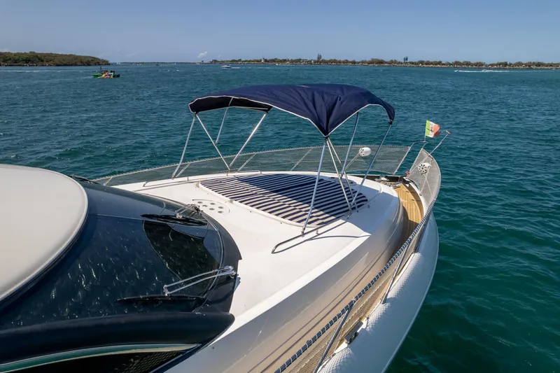 Shhmic Yacht Photos Pics Sunseeker Manhattan 74 yacht, 2001 model, cruising on a sunny day with blue canopy.