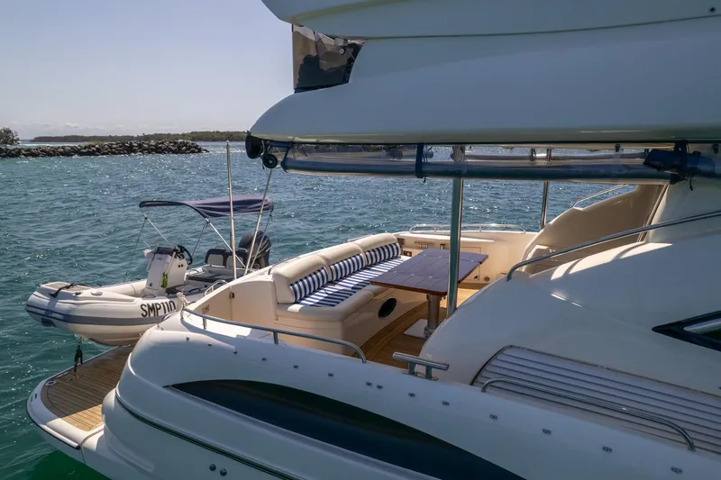 Shhmic Yacht Photos Pics Sunseeker Manhattan 74 yacht, 2001 model, with spacious deck and seating area on the water.