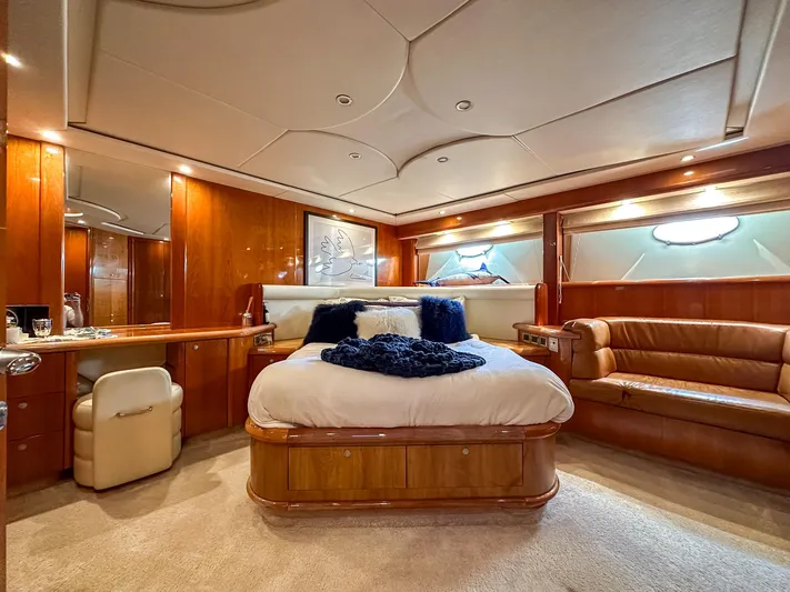 Shhmic Yacht Photos Pics Luxurious bedroom interior of 2001 Sunseeker Manhattan 74 yacht with elegant wood finishes.