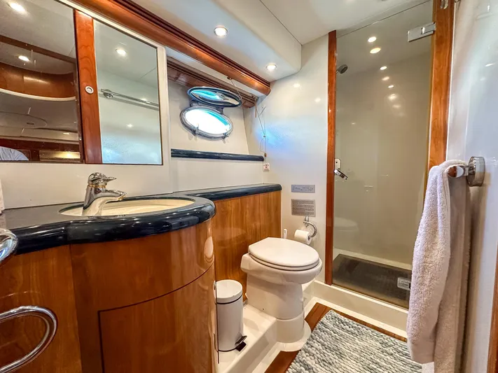 Shhmic Yacht Photos Pics Luxurious bathroom in 2001 Sunseeker Manhattan 74 yacht with modern fixtures and elegant wood finishes.