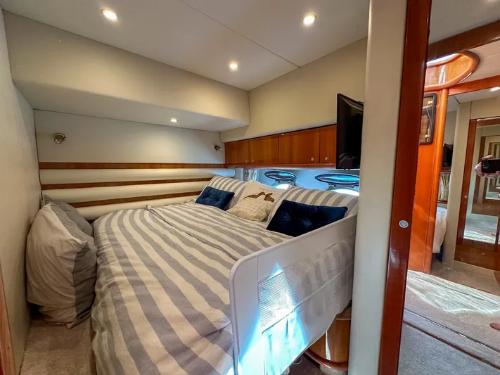 Shhmic Yacht Photos Pics Luxurious bedroom interior of 2001 Sunseeker Manhattan 74 yacht with striped bedding.