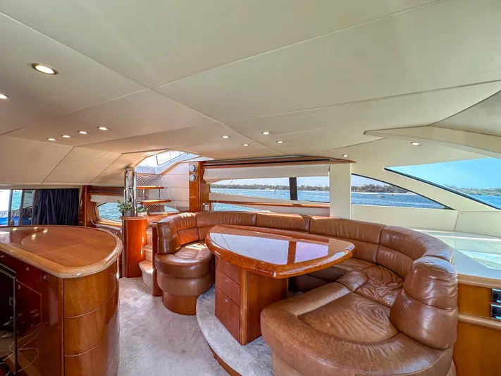 Shhmic Yacht Photos Pics Luxurious interior of 2001 Sunseeker Manhattan 74 yacht with leather seating and wooden accents.