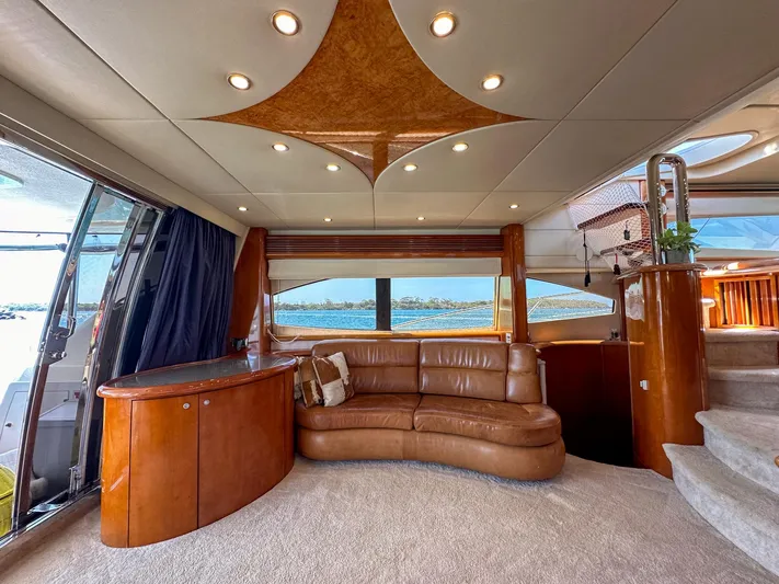 Shhmic Yacht Photos Pics Luxurious interior of 2001 Sunseeker Manhattan 74 yacht with leather seating and elegant wood finishes.