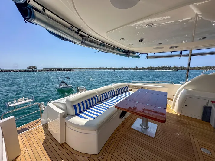 Shhmic Yacht Photos Pics Luxurious Sunseeker Manhattan 74 yacht deck with seating, ocean view, and wooden flooring.