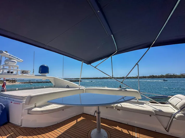 Shhmic Yacht Photos Pics Sunseeker Manhattan 74 yacht deck with seating, table, and ocean view, 2001 model.