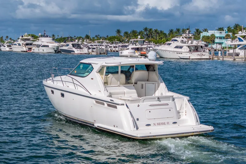  Yacht Photos Pics 2007 Tiara Yachts 4300 Sovran cruising in a marina with other boats.