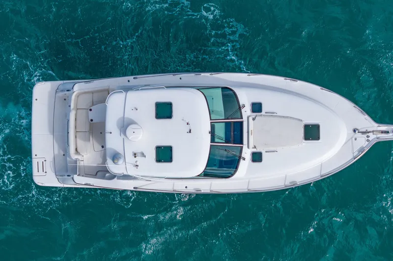  Yacht Photos Pics Aerial view of 2007 Tiara Yachts 4300 Sovran cruising on turquoise waters.