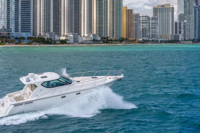  Yacht Photos Pics 2007 Tiara Yachts 4300 Sovran cruising near city skyline and turquoise waters.