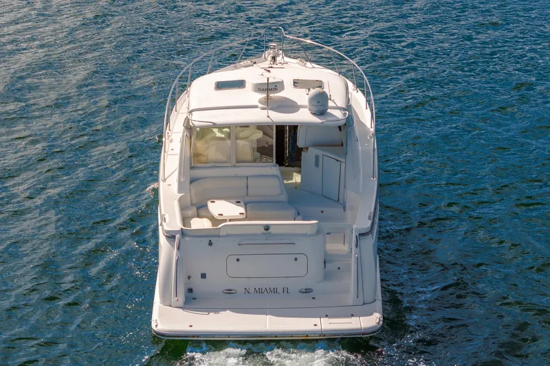  Yacht Photos Pics 2007 Tiara Yachts 4300 Sovran cruising on open water, rear view.