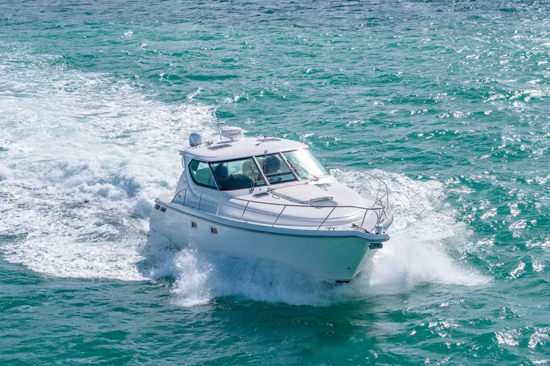  Yacht Photos Pics 2007 Tiara Yachts 4300 Sovran cruising on turquoise ocean waters.