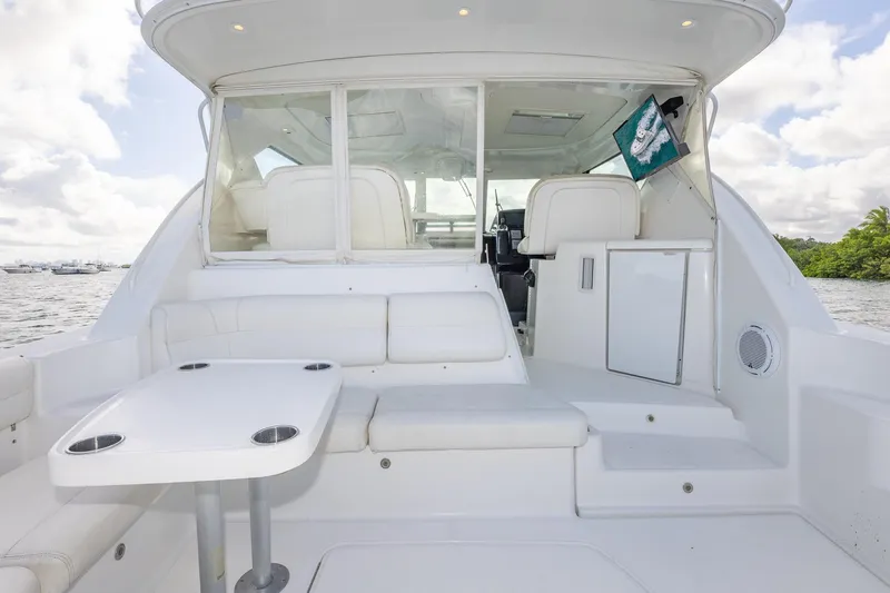  Yacht Photos Pics 2007 Tiara Yachts 4300 Sovran interior with seating and table, docked on a sunny day.