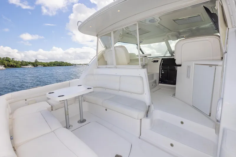  Yacht Photos Pics 2007 Tiara Yachts 4300 Sovran interior with white seating and table, overlooking serene waters.
