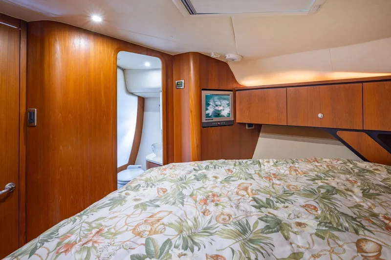  Yacht Photos Pics Luxurious 2007 Tiara Yachts 4300 Sovran cabin with wood paneling and floral bedding.