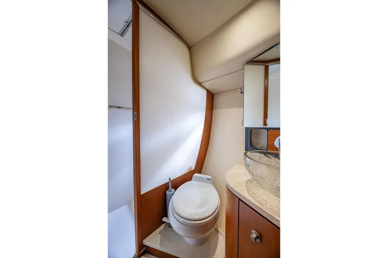  Yacht Photos Pics 2007 Tiara Yachts 4300 Sovran bathroom with modern fixtures and wooden cabinetry.