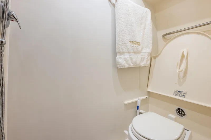  Yacht Photos Pics Bathroom interior of 2007 Tiara Yachts 4300 Sovran, featuring toilet and towel.