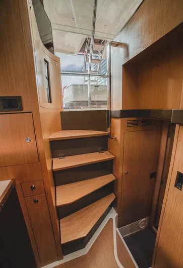  Yacht Photos Pics Interior staircase of 2011 Riva SportRiva 56 yacht, featuring wooden steps and modern design.
