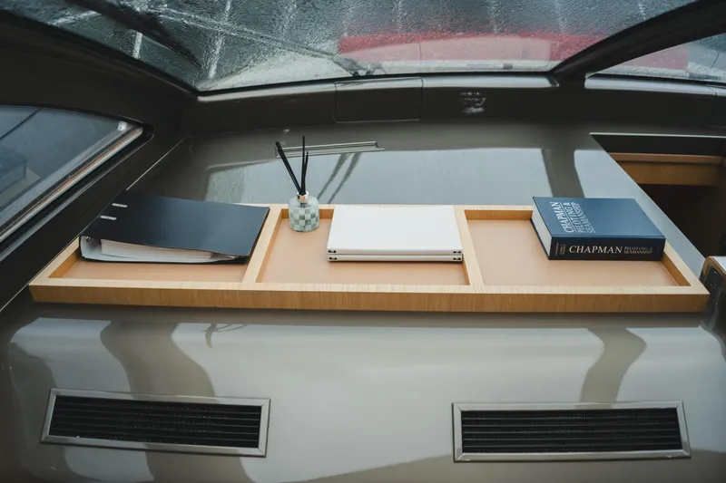  Yacht Photos Pics Interior of 2011 Riva SportRiva 56 yacht with books and decor on a wooden shelf.