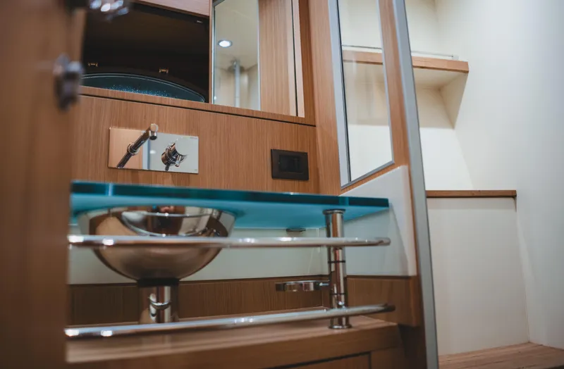  Yacht Photos Pics Luxurious bathroom interior of 2011 Riva SportRiva 56 yacht with modern sink and wooden accents.