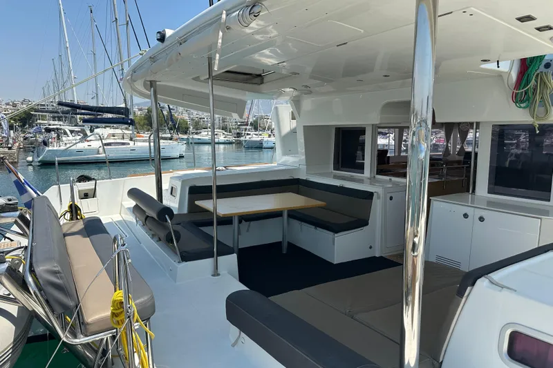  Yacht Photos Pics Spacious 2012 Lagoon 450 catamaran with outdoor seating, docked at a marina.