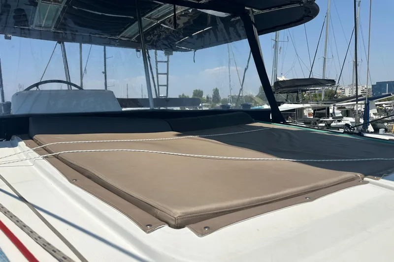  Yacht Photos Pics 2012 Lagoon 450 catamaran with sunbathing area, docked at marina under clear sky.