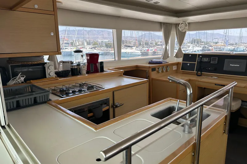 Yacht Photos Pics Interior of 2012 Lagoon 450 yacht kitchen with modern appliances and marina view.