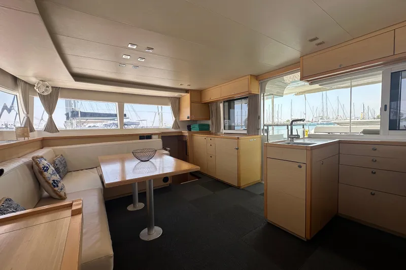  Yacht Photos Pics Interior of 2012 Lagoon 450 catamaran with modern kitchen and seating area.