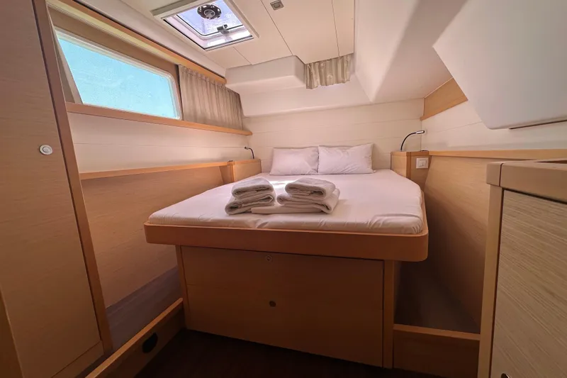  Yacht Photos Pics Luxurious cabin interior of 2012 Lagoon 450 yacht with cozy bed and natural light.