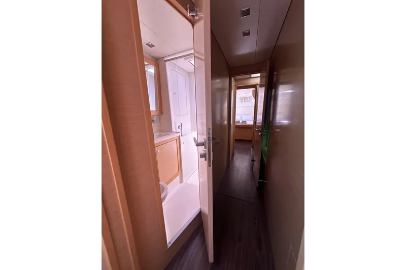  Yacht Photos Pics Interior hallway of 2012 Lagoon 450 yacht, featuring bathroom and cabin access.