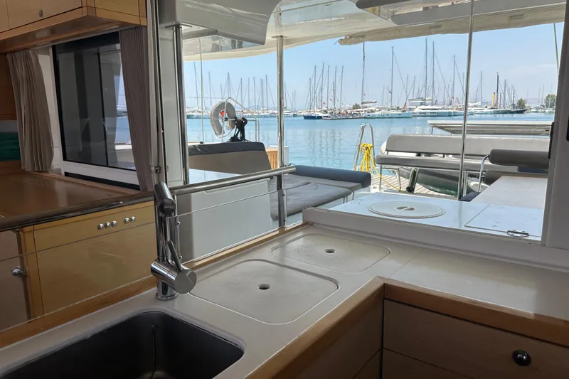  Yacht Photos Pics Interior view of 2012 Lagoon 450 yacht kitchen with marina backdrop.