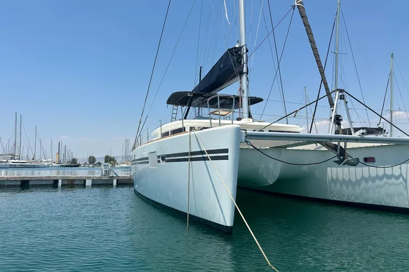  Yacht Photos Pics 2012 Lagoon 450 catamaran docked in a marina under clear blue skies.