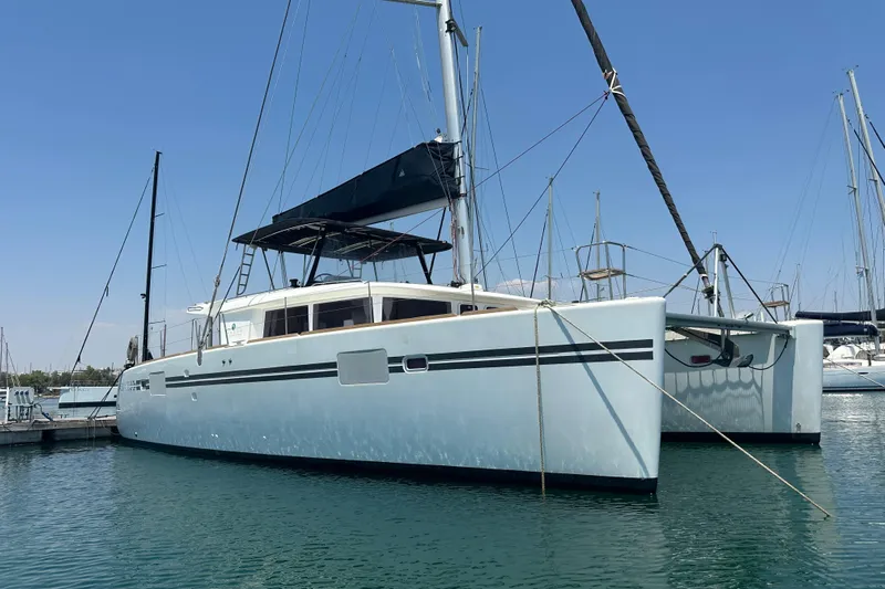  Yacht Photos Pics 2012 Lagoon 450 catamaran docked in marina under clear blue sky.