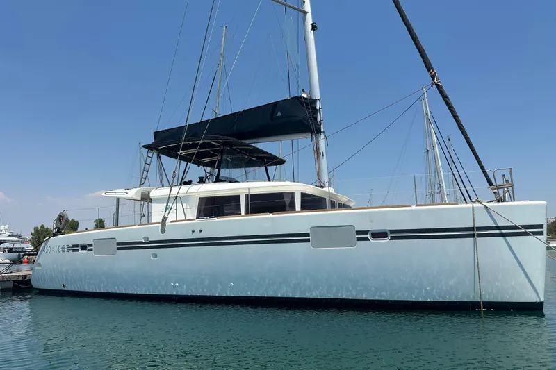  Yacht Photos Pics 2012 Lagoon 450 catamaran docked in a marina under clear blue skies.