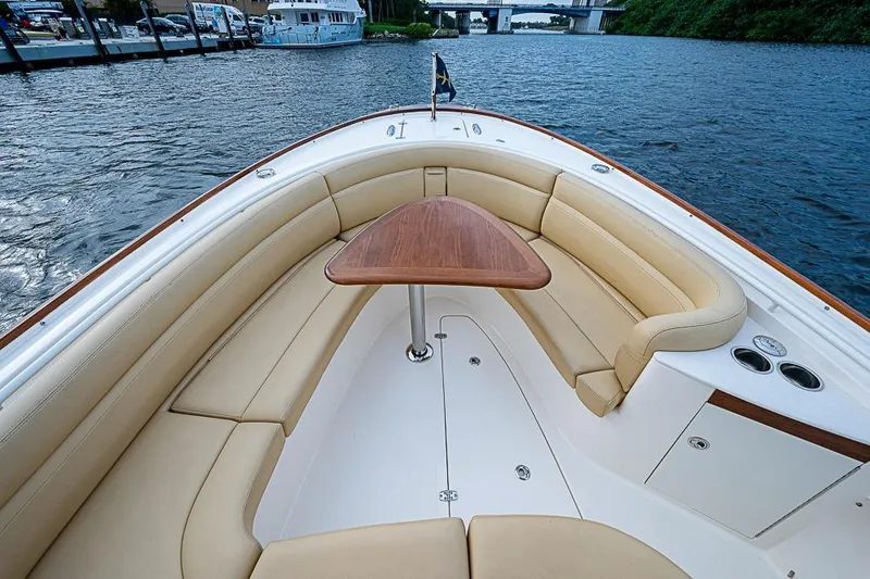 Blue Streak Yacht Photos Pics 2018 Hunt Yachts 32 Center Console with elegant seating and wooden table on calm waters.