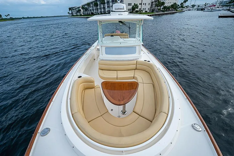 Blue Streak Yacht Photos Pics 2018 Hunt Yachts 32 Center Console with tan seating and wooden table on open water.