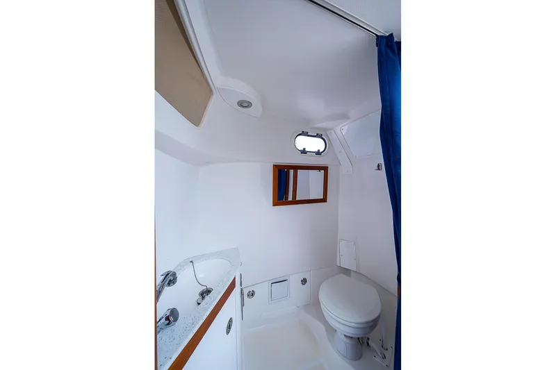 Blue Streak Yacht Photos Pics 2018 Hunt Yachts 32 Center Console bathroom with sink, toilet, and porthole window.