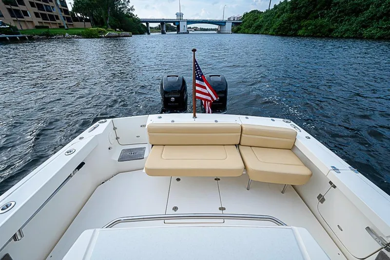 Blue Streak Yacht Photos Pics 2018 Hunt Yachts 32 Center Console with seating and American flag on a calm river.