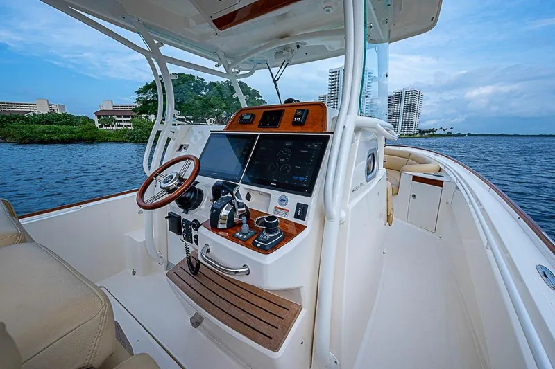 Blue Streak Yacht Photos Pics 2018 Hunt Yachts 32 Center Console, luxurious helm with advanced navigation, on serene waters.