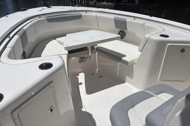 300 - 112 Brokerage Kevin Yacht Photos Pics 2023 Robalo R302 Center Console boat interior with seating and table.