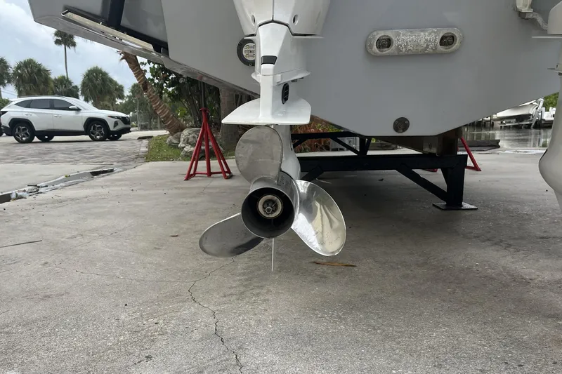 300 - 112 Brokerage Kevin Yacht Photos Pics 2023 Robalo R302 Center Console boat propeller on a trailer, parked outdoors.